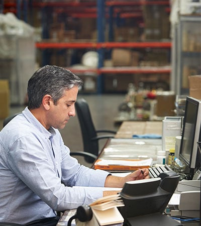 3PL-Freight-Brokerage-associate-working-out-of-a-warehouse